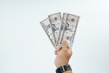 Hand holding US dollar banknote on white background representing payment, cash transaction, financial exchange, income, salary, and money concept with copy space.