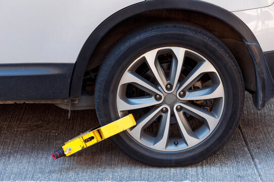 Parking wheel clamp on a car's tire.