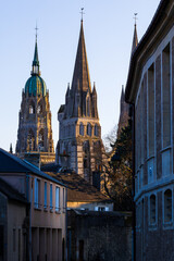 Obraz premium Central tower of Notre-Dame Cathedral of Bayeux, richly decorated Gothic architecture highlighted by the setting sun