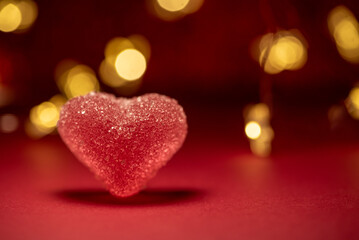 Pink Sugar Heart on Red Background with Bokeh Lights. Valentine's Day Celebration