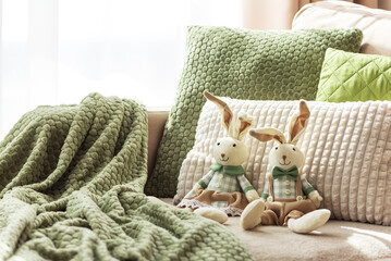 Cozy Sofa with Plush Easter Bunny Dolls and Textured Pillows in Sunlight