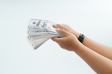 Hand holding US dollar banknote on white background representing payment, cash transaction,...