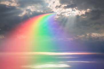 Beautiful calm sea landscape with amazing rounded rainbow at amazing sunset