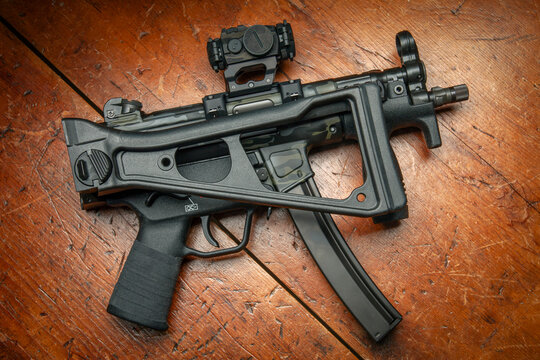 Heckler & Koch SP5K folding stock. Limited edition Cerakote paint, Aimpoint T-2 Micro Red dot sight, Goon tape fabric wrap grip.