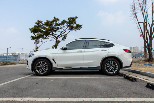 March 14, 2021, Seoul, South Korea - A white BMW X4 20i luxury compact SUV parked in an outdoor parking lot.