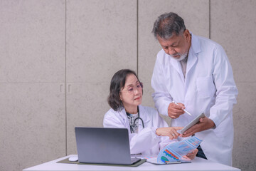 Concentrated senior medical experts discussion about patient diagnosis health care report in serious hospital workplace