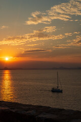 Sailboat under dramatic sunset sky Greece