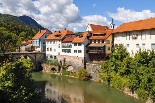 Visitors admire the historic architecture and scenic views along the river Sora  in Skofja Loka, a captivating medieval town in Slovenia.
