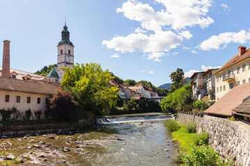 Fototapeta premium Explore Skofja Loka with its charming old town and historic architecture near a flowing river Sora and picturesque surroundings.