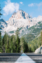 Mountain Road - Dolomites National Park Italy - Alpine landscape with mountains and pine trees in autumn fall summer - panoramic aerial view