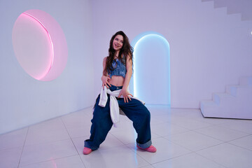 Energetic dance performance in a modern studio with colorful lighting