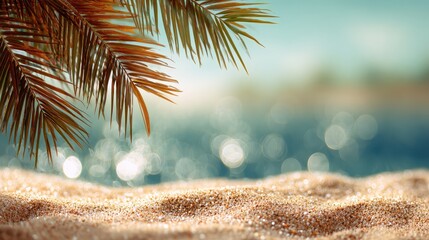 Sand with blurred palms and tropical bokeh creates a summer vacation concept with relaxing copy space.
