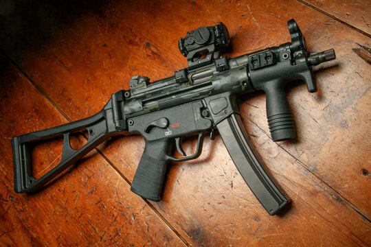 Heckler & Koch SP5K with folding stock. Limited edition Cerakote paint, Aimpoint T-2 Micro Red dot sight, Goon tape fabric wrap and M-LOK aluminum rail.