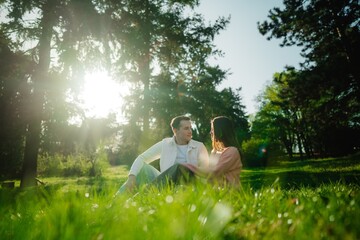 Couple enjoying a romantic moment in a sunlit forest glade