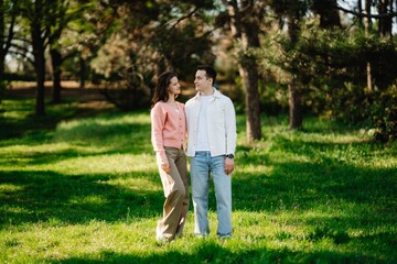 Couple enjoys a serene moment in a lush green park during sunny afternoon