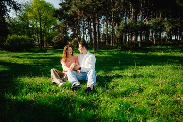Couple enjoys a sunlit afternoon in a lush green forest clearing together