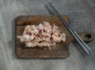 Top view of Delicious Crispy And Crunchy Deep-Fried Calamari or Crispy Deep-Fried Squid and Silver chopsticks served on Wooden cutting board, use it as your Wallpaper, Poster and Copy space.