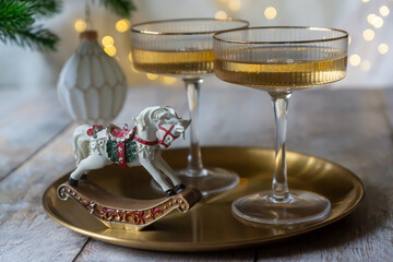 New Year 2026: champagne and Christmas tree decorations on the table.