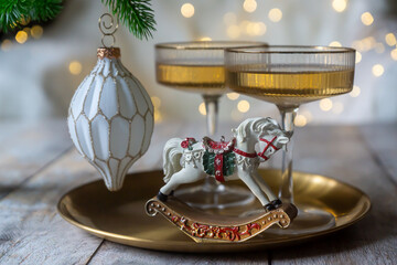 New Year 2026: champagne and Christmas tree decorations on the table.