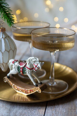 New Year 2026: champagne and Christmas tree decorations on the table.