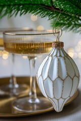 New Year 2026: champagne and Christmas tree decorations on the table.
