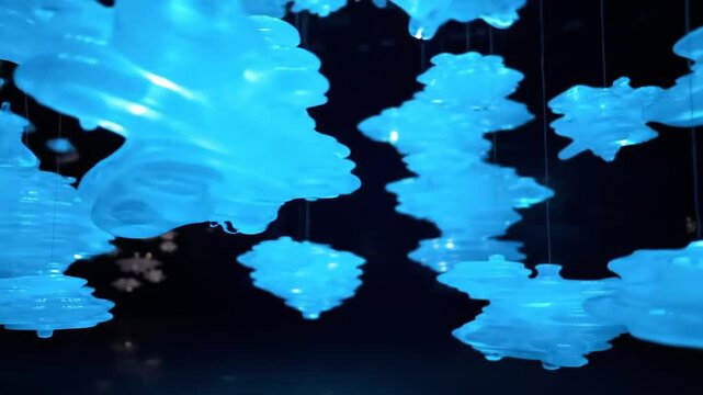 A mesmerizing display of glowing blue objects suspended in mid-air, creating an ethereal atmosphere