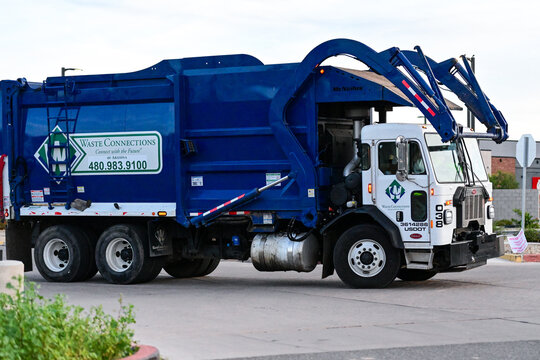 Automated recycling truck operated by a waste management company, illustrating municipal waste collection, recycling services, and sanitation fleet operations