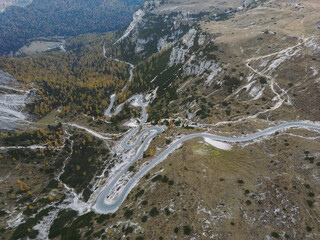 Mountain Road - Dolomites National Park Italy - Alpine landscape with mountains and pine trees in autumn fall summer - panoramic aerial view