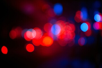 Multiple blurred circles of red, blue, and purple light float on a dark background, creating an abstract bokeh pattern that evokes energy, mystery, or nightlife ambiance