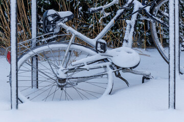 Bicycle covered with snow parked outdoors in winter