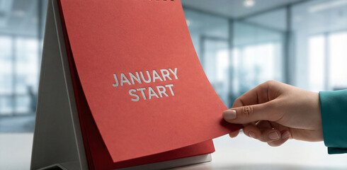 January Start: Hand Turns Desk Calendar Page in a Modern Office, Signaling New Year's Goals, Business Planning & Fresh