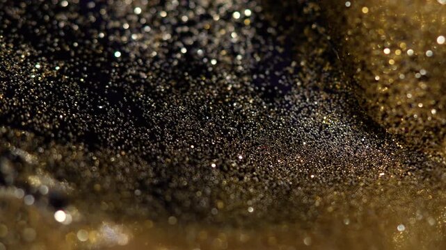 Golden shimmering dust particles in macro close-up, creating a dreamy abstract texture with soft bokeh and high-detail cosmic sparkle. Ideal for luxury, backgrounds, cinematic visuals and design.