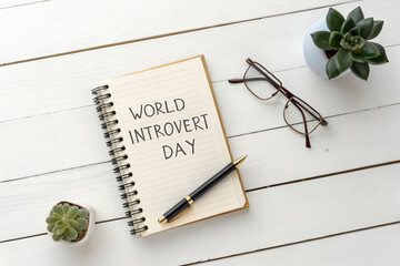 World Introvert Day Flat Lay: Spiral Notebook with Pen, Succulents, and Eyeglasses on White Wooden Surface Celebrating Calm and Personal Reflection generative ai