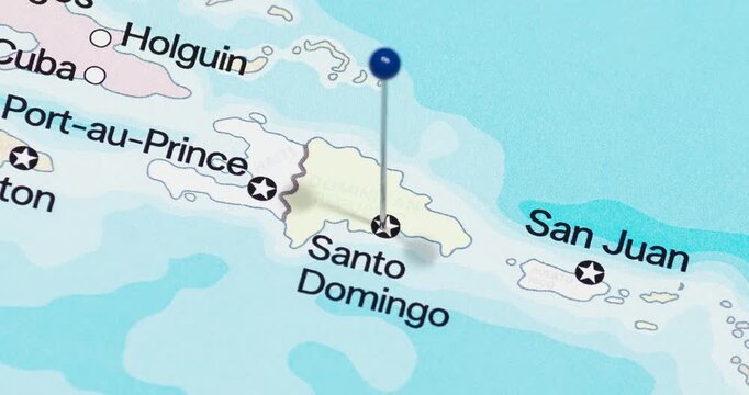 A zoom out of a blue pin into santo domingo city of dominican republic political map