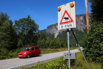 Moose crossing warning sign at a mountain road in Setesdal valley in Agder county, Norway.
