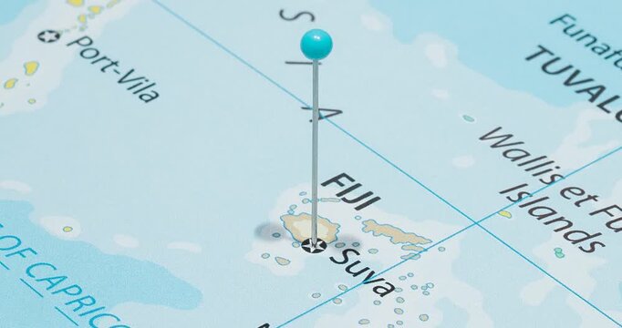 A zoom out of a light blue pin into suva city of fiji political map