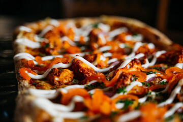 A pizza with white sauce and red peppers