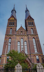 Fototapeta premium Twin church towers rising above historic European city architecture