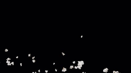 Popcorn blows up in the air with a black background in slow motion. - Powered by Adobe