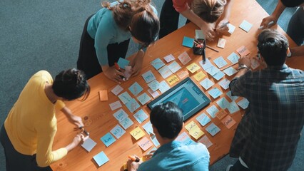 Top view of skilled programmer brainstorming idea about mobile phone interface while develop app development by using wireframe prototype. Web designer planning at table with sticky notes. Symposium.