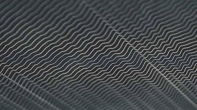 An abstract background depicting a force field or energy flow. Diagonal glowing lines vibrate on a dark surface. This seamless 4K animation is ideal for science, technology, and sci-fi themes