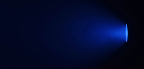 Close up of a studio spotlight emitting a focused cool blue light with a soft gradient in a dark room. Lighting equipment backstage.