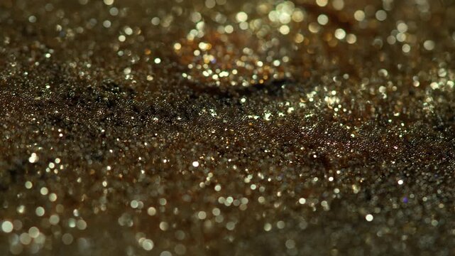Golden Liquid Abstract glitter particles shimmering on fluid macro texture, ideal for VFX overlays, luxury branding, cinematic backgrounds, celebration visuals motion graphics desing