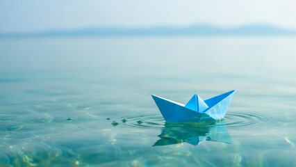 Obraz premium Paper Boat Dreams Blue Origami Voyage on Tranquil Turquoise Waters.