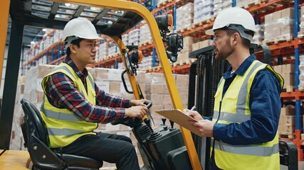 Warehouse worker operating forklift near colleague with clipboard - Powered by Adobe