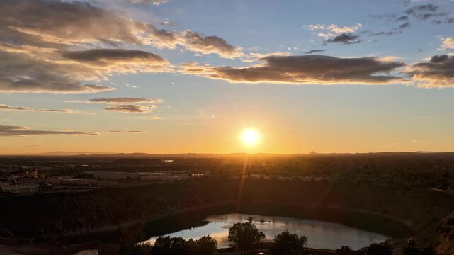 time lapseAerial footage of a lake surrounded by homes and lush green trees at sunset in Duarte California USA