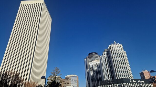 Madrid, spain - 30 december 2025 - azca financial district buildings reaching clear blue sky