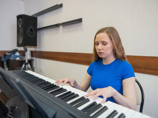 Caucasian woman playing electric piano. 