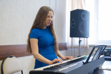Caucasian woman playing electric piano. 