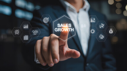 Businessman Pressing Sales Growth Button on Futuristic Virtual Screen for Strategic Financial Planning.png